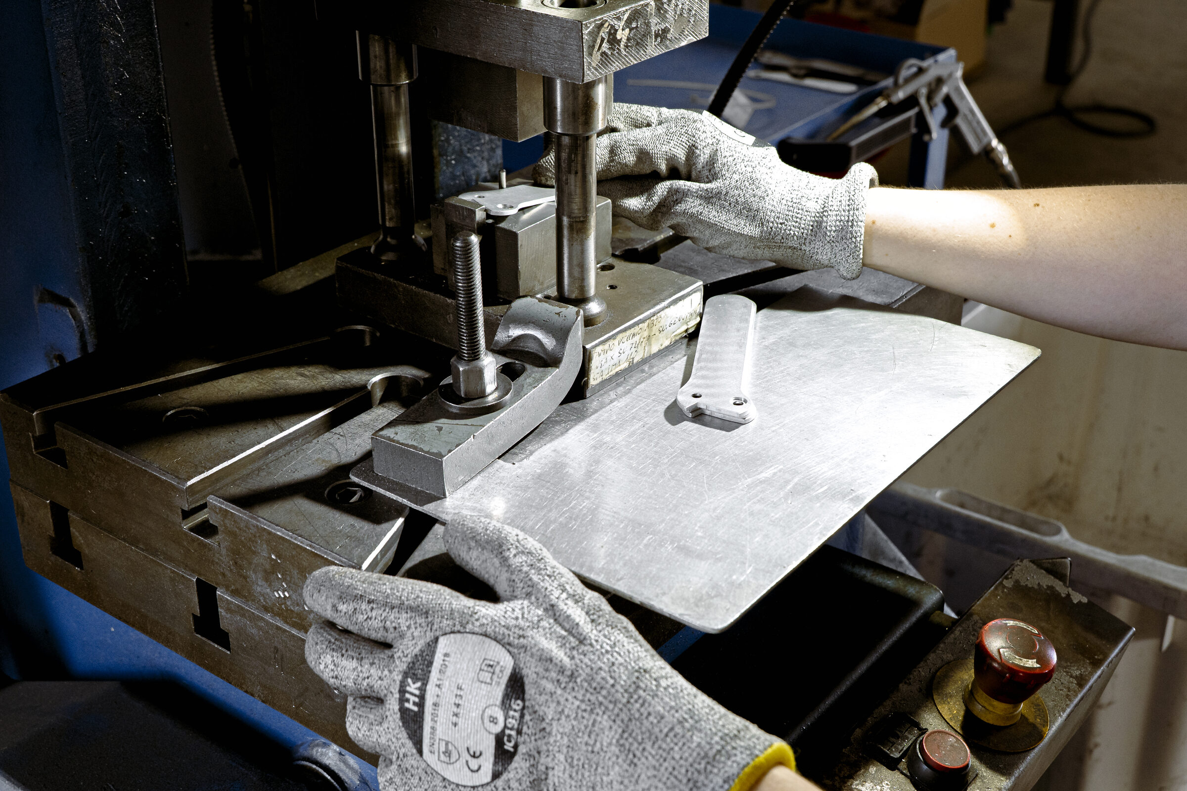 Operator working at a mechanical stamping press in the Narco Service plant